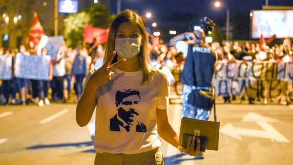 This photograph taken on September 15, 2020, shows a protestor wearing a T-shirt with an image of revolutionary figure Goce Delchev, gesturing as she takes part in an anti-government protest in Skopje. After changing its name last year to settle a decades-old battle with Greece, the small Balkan state of North Macedonia was finally on a path to join the European Union. Until Bulgaria stepped in. Robert ATANASOVSKI / AFP
