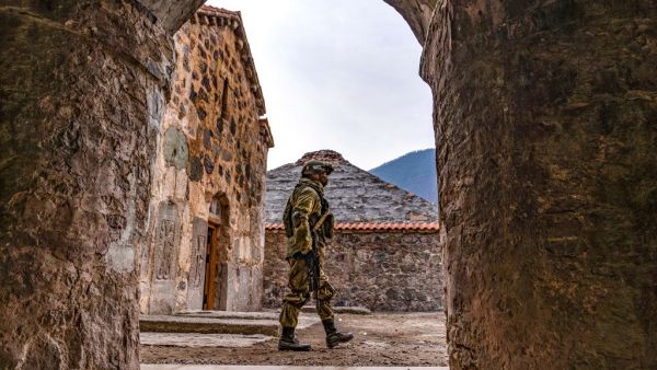 A Russian peacekeeper walks past along a yard of the 12th-13th century Orthodox Dadivank Monastery, outside the town of Kalbajar on November 16, 2020, after the monastery was put under their protection as part of the peace agreement putting an end to the military conflict between Armenia and Azerbaijan. (AFP/File)