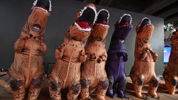 Protesters dressed in dinosaur costumes -- which pro-democracy activists said represents the older generation of Thai politicians -- take part in a 'Bad Student' rally in Bangkok on November 21, 2020. Mladen ANTONOV / AFP