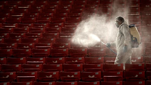 A member of the Guadalajara staff disinfects the stands before the start of the repechage football match of the Mexican Apertura tournament between Guadalajara and Necaxa at the Akron stadium in Guadalajara, Jalisco state, Mexico, on November 21, 2020, during the COVID-19 coronavirus pandemic. Ulises Ruiz / AFP