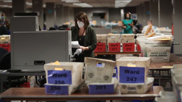 Claire Woodall-Vogg, executive director of the Milwaukee election commission collects the count from absentee ballots from a voting machine on November 04, 2020 in Milwaukee, Wisconsin. Wisconsin requires election officials to wait to begin counting absentee ballots until after polls open on election day. The Milwaukee count was finished about 3AM. Scott Olson/Getty Images/AFP