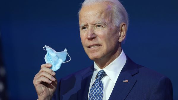 U.S. President-elect Joe Biden holds a protective mask as he speaks to the media after receiving a briefing from the transition COVID-19 advisory board on November 09, 2020 at the Queen Theater in Wilmington, Delaware. Mr. Biden spoke about how his administration would respond to the coronavirus pandemic. Joe Raedle/Getty Images/AFP JOE RAEDLE / GETTY IMAGES NORTH AMERICA / Getty Images via AFP
