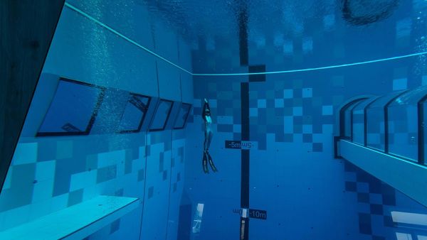 A diver swims in the 148ft-deep pool on its opening day on Saturday. The pool can accommodate customers during the coronavirus pandemic because it is considered a training centre for divers. (AFP)