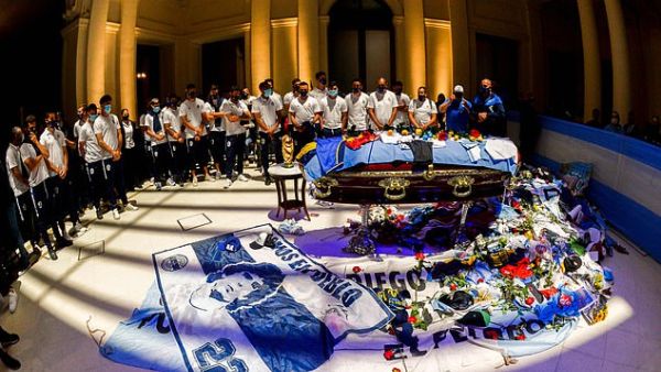 Argentina's football players pay tribute to Maradona as scarves, flags and football jerseys are piled up around the coffin draped in the national flag at his wake in the presidential palace on Thursday. (AFP/File)