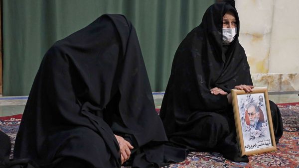Mourners are seen during the funeral procession of Iran's assassinated top nuclear scientist Mohsen Fakhrizadeh at Imam Reza Shrine. (AFP)