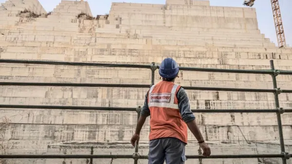 Construction worker eyes progress on the Grand Ethiopian Renaissance Dam in Ethiopia last December (AFP)