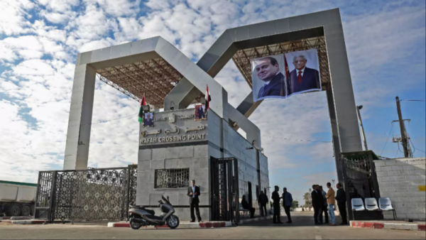 Portraits of Egyptian President Abdel Fattah al-Sisi and Palestinian leader Mahmud Abbas hang at the Rafah border crossing with Egypt. (Said Khatib, AFP )