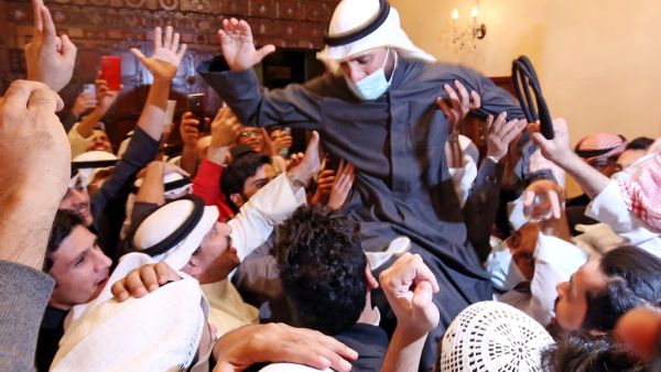 Kuwaiti candidate and Parliament Speaker Marzouq al-Ghanem celebrates with his supporters following the announcement of his victory in parliamentary election in Kuwait city, on December 6, 2020. Unlike other oil-rich Gulf states, Kuwait has a lively political life and its parliament, elected for four-year terms, enjoys wide legislative powers. Political disputes are often fought in public. But with more than 144,000 novel coronavirus cases to date, including 889 deaths, the election campaign has been toned 