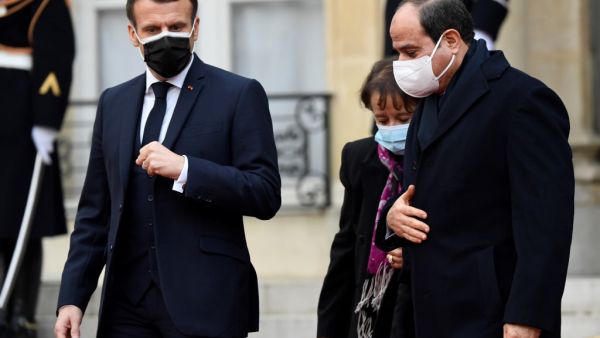 French President Emmanuel Macron (L) escorts his Egyptian counterpart Abdel Fattah al-Sisi (R) out of the Elysee presidential Palace on December 7, 2020 in Paris, after a meeting as part of al-Sisi's three-day state visit to France. Bertrand GUAY / AFP