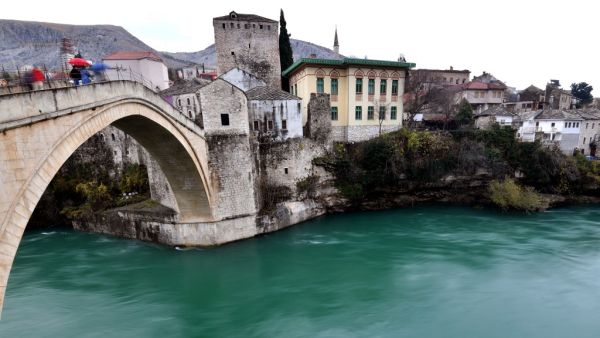 A photo shows deserted streets with scarse passers by in historical core of the Southern-Bosnian town of Mostar, on December 7, 2020. Mostar is the only Bosnian city that has not held local elections in 12 years. Split into Croat and Bosniak zones by the Dayton Peace Agreement, which ended Bosnia's war 25 years ago, the town is a symbol of the broken politics that has haunted the Balkan state ever since. With two nationalist parties in power and unable to agree on voting rules, Mostar has not held local ele