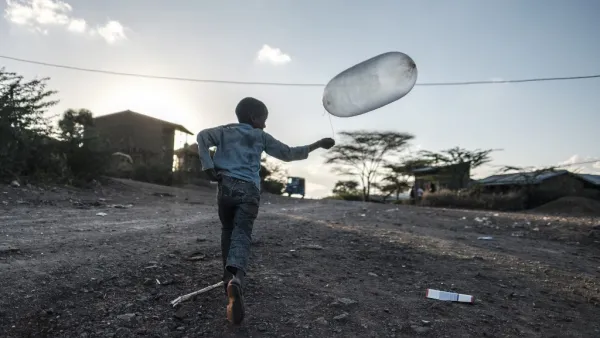A boy runs with a balloon in the village of Bisober, in Ethiopia's Tigray region on December 9, 2020. The November 14 killings represent just one incident of civilian suffering in Bisober, a farming village home to roughly 2,000 people in southern Tigray.  EDUARDO SOTERAS / AFP