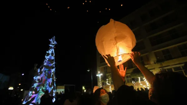Lebanese launch lanterns in Beirut's Gemmayzeh neighbourhood on December 20, 2020, during the lighting of a Christmas tree in memory of the victims of the devastating port blast in that took place in the capital's port in August.  ANWAR AMRO / AFP