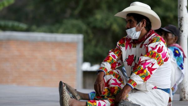 Indigenous Wixarika people from Jalisco and Durango participate in the Wixarika Regional Council in Mezquital, Durango state, Mexico, on December 17, 2020, amid the COVID-19 coronavirus pandemic. The Wixarika Regional Council was formed to defend the Wirikuta Sacred Zone where many ancient traditions and customs are kept alive. ULISES RUIZ / AFP