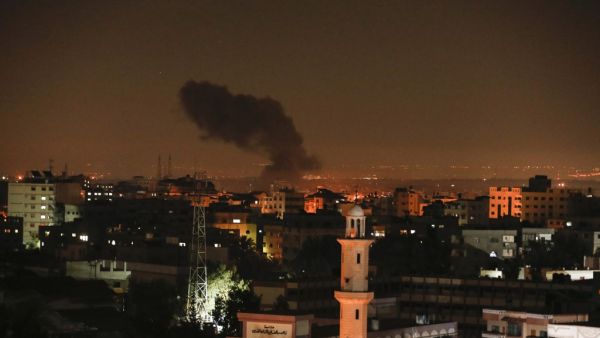 Smoke and flames are seen following an Israeli air strike in Gaza city, on December 26, 2020. MAHMUD HAMS / AFP