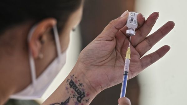 A health worker prepares the Pfizer/BioNTech COVID-19 vaccine jab, at the Military College in Mexico City, on December 27, 2020. Dozens of nurses and doctors felt they had regained "peace of mind" and strength to continue fighting the COVID-19 pandemic, after being vaccinated against the disease this Sunday in Mexico. PEDRO PARDO / AFP
