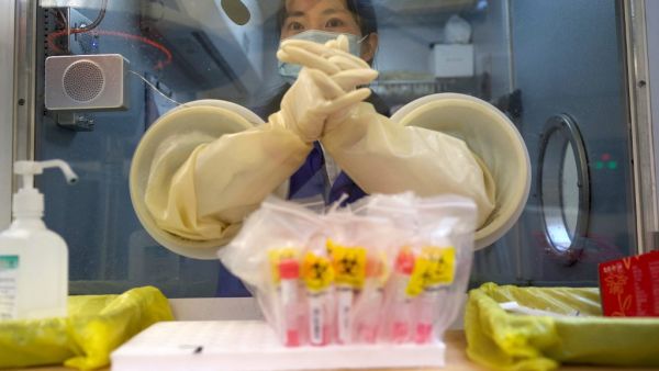 A medical worker waits for the next individual to take a swab test for the COVID-19 coronavirus at a hospital in Beijing in December 30, 2020. Noel Celis / AFP