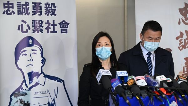 Hong Kong's acting chief superintendent of the Commercial Crime Bureau, Cheng Lai Ki (L), speaks to the media in Hong Kong on December 30, 2020, after the release of the two youngest members of the so-called "Hong Kong 12" held over the border in the southern Chinese city of Shenzhen since last August when the 12 were caught trying to flee the territory for Taiwan. Peter PARKS / AFP