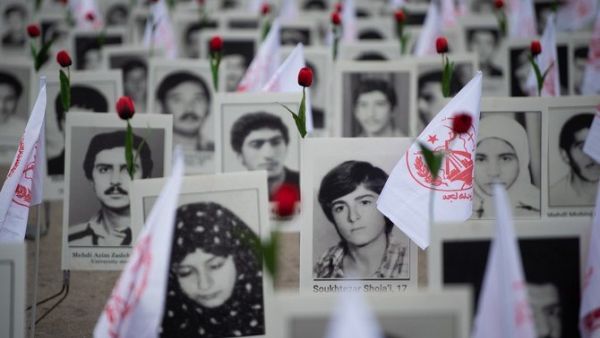 Portraits of victims killed in Iran's massacres of dissidents in 1988 on display at a memorial in France last year. (AFP/File)