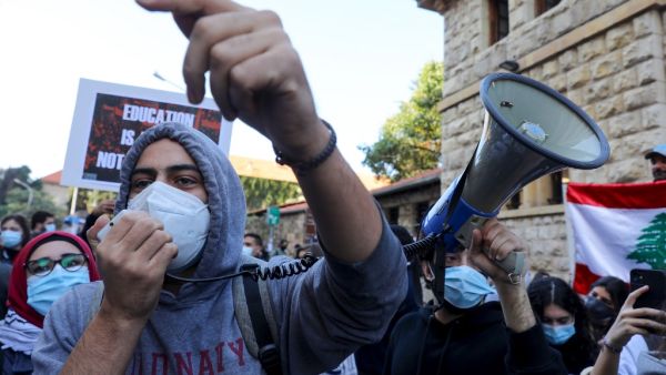 Demonstrators chant slogans during a demonstration outside the entrance of the American University of Beirut, in the Lebanese capital's Bliss street on December 29, 2020, against the decision by a number of universities to adopt a new dollar exchange rate to price tuition. ANWAR AMRO / AFP