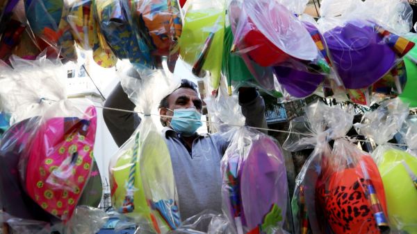 A vendor sells party supplies ahead of New Year on December 31, 2020 in Beirut. ANWAR AMRO / AFP