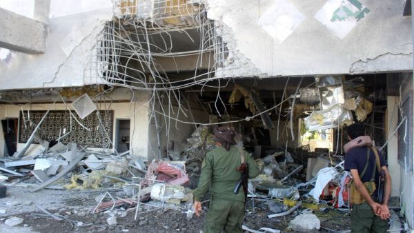 Fighters with the Saudi-backed coalition assess the damage inside the airport of Yemen's southern city of Aden on December 31, 2020, a day after explosions rocked the building, killing or injuring dozens of people.  Saleh Al-OBEIDI / AFP