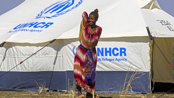 An Ethiopian refugee, who fled the Tigray conflict, walks in the Tenedba camp in Mafaza, eastern Sudan on January 8, 2021, after being transported from the reception center. ASHRAF SHAZLY / AFP