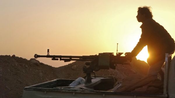 In this file photo a combatant mans a heavy machine gun as forces loyal to Yemen's Saudi-backed government clash with Huthi rebel fighters around the strategic government-held "Mas Camp" military base, in al-Jadaan area about 50 kilometres northwest of Marib in central Yemen, on November 22, 2020. AFP