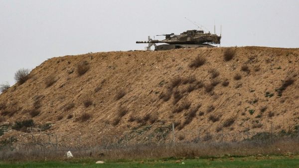 An Israeli tank is pictured on Israel's border with Gaza, opposite the Palestinilan city of Khan Yunis in the southern Gaza Strip, on January 13, 2021. The Israeli army fired artillery at Hamas targets in Gaza in response to what it described as gunfire from within Gaza on an "engineering vehicle" operating near the border.  SAID KHATIB / AFP
