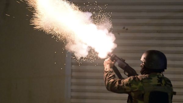 Tunisian security forces fire tear gas as protesters block a street in the Ettadhamen city suburb on the northwestern outskirts of Tunis on January 18, 2021, amidst a wave of nightly protests in the North African country. The social unrest comes at a time of economic crisis, worsened by the pandemic, that has sparked rapid inflation and high youth unemployment and led many people to leave Tunisia. FETHI BELAID / AFP