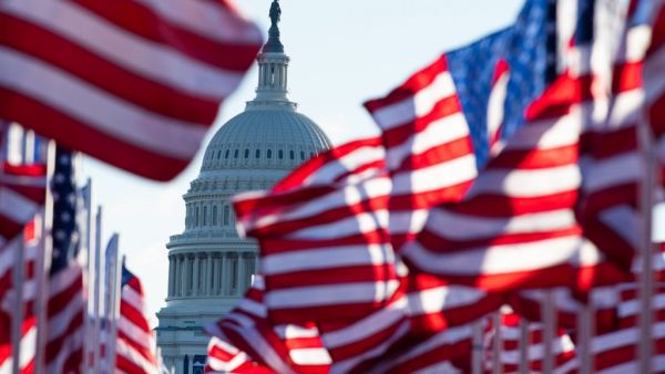US flags representing those who could not attend the inauguration due to Covid-19, flutter in the wind at the Mall before the Inauguration of US President-Elect Joe Biden in Washington, DC on January 20, 2021. ROBERTO SCHMIDT / AFP