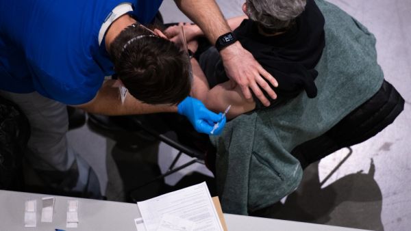 A patient receives a Covid-19 vaccine at the Virginia Mason vaccine clinic hosted at the Amazon Meeting Center in downtown Seattle, Washington on January 24, 2021. Amazon is partnering with Virginia Mason for a one-day pop-up clinic on January 24. 2021 that aims to vaccinate 2,000 people at the company’s Meeting Center near downtown Seattle. Virginia Mason is handling vaccine administration, while Amazon is providing the location and help with logistics. Grant HINDSLEY / AFP