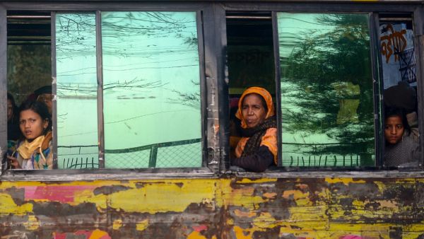 Rohingya refugees look out from a bus headed to a Bangladeshi navy ship in Chittagong on January 30, 2021, that will take them to be relocated to Bhashan Char island in the Bay of Bengal. Munir UZ ZAMAN / AFP
