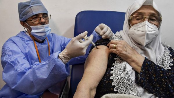 A medical worker administers a dose of Russia's Sputnik V vaccine for COVID-19 coronavirus disease upon a woman at a clinic in the city of Blida, about 45 kilometres southwest of the Algerian capital, on January 30, 2021, where the North African country is symbolically starting its vaccination drive at the same place to have registered the first novel coronavirus case in 2020. At the end of December, Algiers announced an order of 500,000 doses of Sputnik V vaccine from its Russian ally. RYAD KRAMDI / AFP