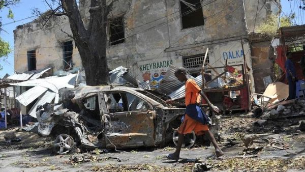 A boy walks past the site of a car bomb attack near a security checkpoint in the Somali capital, not far from the presidential palace in Mogadishu. (File/AFP)