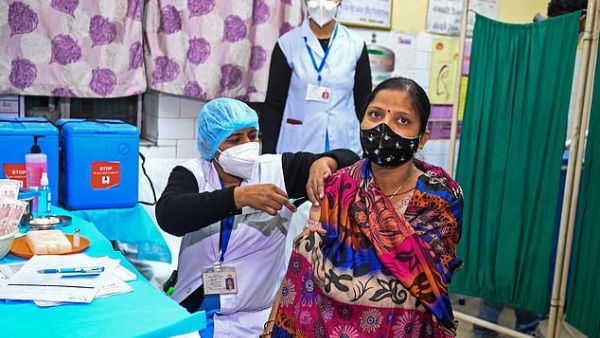 Health officials and a volunteer take part in a dry run, also known as a mock drill, for the Covid-19 vaccine delivery at a health centre in New Delhi, India, on January 2. (AFP)