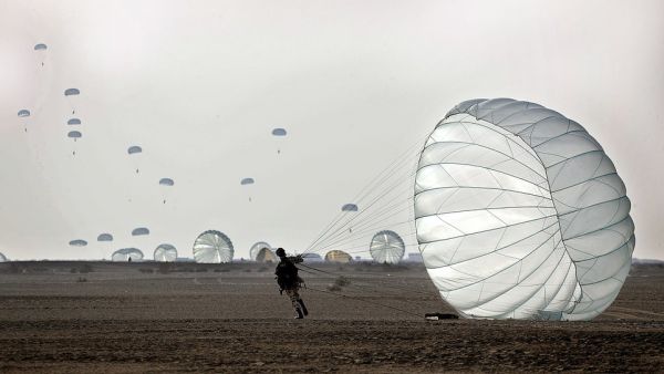 Tuesday's drill is the latest in a series of military exercises by Iran. On Friday, the Iranian Revolutionary Guard Corps' aerospace division launched surface-to-surface ballistic missiles and drones against 'hypothetical enemy bases'. Pictured: A paratrooper lands during a drill by the Iranian military on Tuesday. (AFP)
