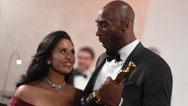 In this file photo taken on March 05, 2018 US actor and basketball player Kobe Bryant (R) holds an oscar beside his wife Vanessa Laine Bryant during the 90th Annual Academy Awards in Hollywood, California. (ANGELA WEISS / AFP)