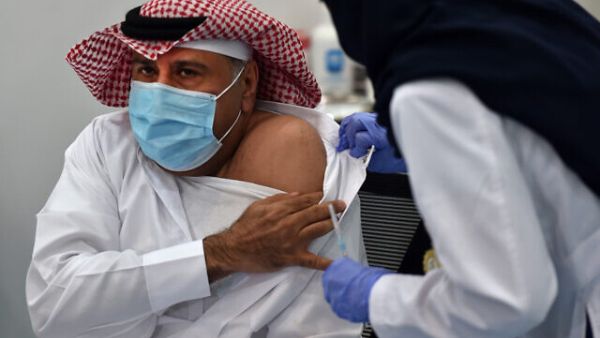 The first Saudi citizen to receive the Pfizer-BioNTech COVID-19 vaccine prepares for the shot in Riyadh, Saudi Arabia. (Fayez Nureldine/AFP)