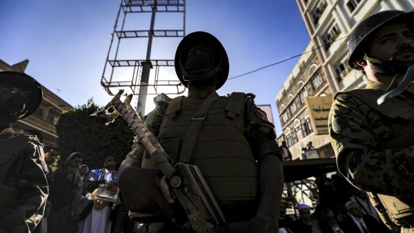A member of security forces loyal to Yemen's Huthi rebels stands guard as supporters attend a rally denouncing the United States and the outgoing Trump administration's decision to apply the "terrorist" designation to the Iran-backed movement, in the Huthi-held capital Sanaa on January 25, 2021. Mohammed HUWAIS / AFP