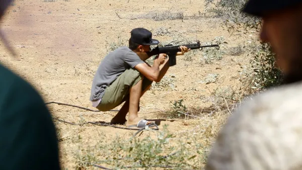 In this file photo taken on June 19, 2019 a fighter loyal to the internationally-recognised Libyan Government of National Accord (GNA) holds a rifle from a position in the al-Sawani area south of the Libyan capital Tripoli during clashes with forces loyal to strongman Khalifa Haftar. Mahmud TURKIA / AFP