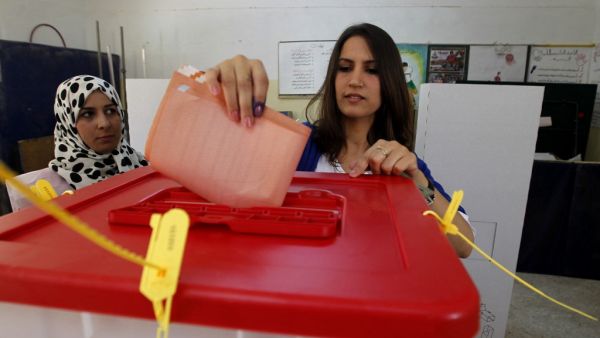 In this file photo taken on July 7, 2012, a woman casts her ballot at a polling station in the eastern city of Benghazi during Libya's General National Congress election. Ten years after Libya's NATO-backed uprising ousted and killed dictator Moamer Kadhafi, the country remains wracked by conflict and chaos, its population bled dry despite the nation's vast oil wealth. A UN-led process has lifted cautious hopes that the latest fragile ceasefire will bring a lasting peace, but, for now, Libya is split in two
