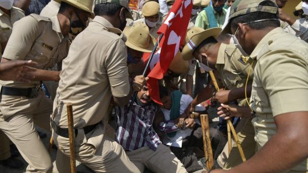 Police personnel detain protesting farmers belonging to the Karnataka Rajya Raitha Sangha (KRRS) gathered to take part and support the ongoing protests against the central government's recent agricultural reforms, in Tumkur district of Karnataka state on February 6, 2021. Manjunath Kiran / AFP
