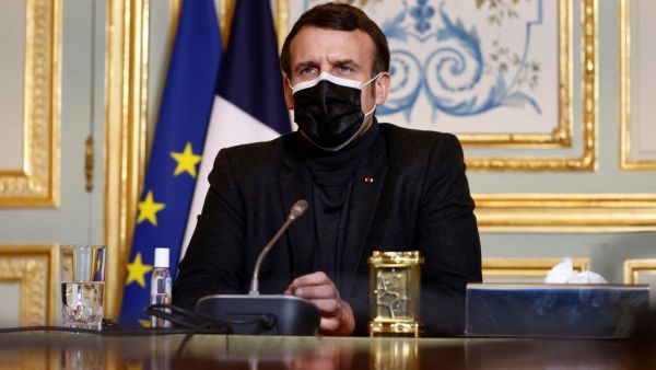 French President Emmanuel Macron, wearing a protective face mask, attends a video-conference meeting with World Health Organization (WHO) Director-General Tedros Adhanom Ghebreyesus (unseen) at the Elysee Palace in Paris amid the coronavirus disease (COVID-19) pandemic on February 8, 2021. CHRISTIAN HARTMANN / POOL / AFP