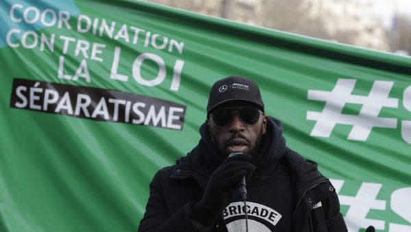 A member of the anti-negrophobia brigade named Issa speaks as protesters demonstrate against a bill dubbed as "anti-separatism", in Paris on February 14, 2021. GEOFFROY VAN DER HASSELT / AFP