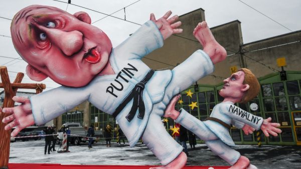 A carnival float depicting Russian opposition leader Alexei Navalny (R) dressed as a judoka kicking the balls of Russian President Vladimir Putin is seen during a slimmed down version of the traditional Rose Monday parade on February 15, 2021 in Duesseldorf, western Germany. Due to the novel coronavirus COVID-19 pandemic, traditional parades and festivities in Germany's carnival hotspots, mainly situated in the Rhineland region, had to be canceled or modified to conform to the rules and restrictions in orde
