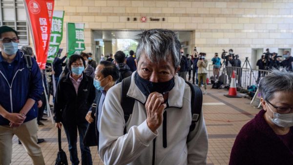 Hong Kong pro-democracy activists Lee Cheuk-yan (front C), Albert Ho, (behind centre L) and Cyd Ho (R) enter the West Kowloon Magistrates Court in Hong Kong on February 16, 2021, as veteran activists go on trial for organising one of the biggest democracy protests to sweep the city in 2019. Anthony WALLACE / AFP