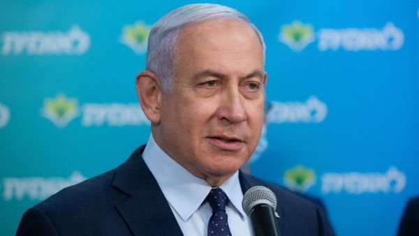 Israeli Prime Minister Netanyahu attends a ceremony marking the 4,000,000th person to be vaccinated at Leumit Health Care Services vaccination facility in Jerusalem on February 16, 2021. Israel's largest healthcare provider said a study of more than half a million fully vaccinated Israelis indicated the Pfizer/BioNTech jab gave 94 percent protection against Covid-19. Alex KOLOMIENSKY / POOL / AFP