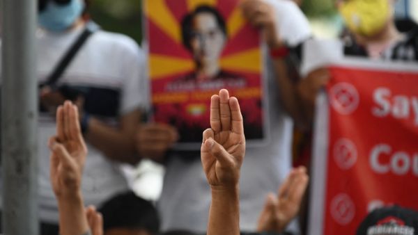 Protesters hold up the three finger salute during a demonstration against the military coup in Yangon on February 17, 2021. Sai Aung Main / AFP