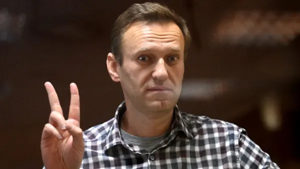 Russian opposition leader Alexei Navalny stands inside a glass cell during a court hearing at the Babushkinsky district court in Moscow on February 20, 2021. The Kremlin's most prominent opponent Alexei Navalny faces two court decisions on Saturday that could seal a judge's ruling to jail him for several years, after he returned to Russia following a poisoning attack. Kirill KUDRYAVTSEV / AFP