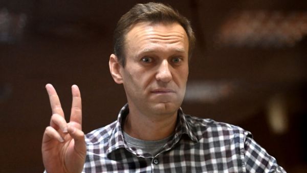 Russian opposition leader Alexei Navalny stands inside a glass cell during a court hearing at the Babushkinsky district court in Moscow on February 20, 2021. The Kremlin's most prominent opponent Alexei Navalny faces two court decisions on Saturday that could seal a judge's ruling to jail him for several years, after he returned to Russia following a poisoning attack. Kirill KUDRYAVTSEV / AFP